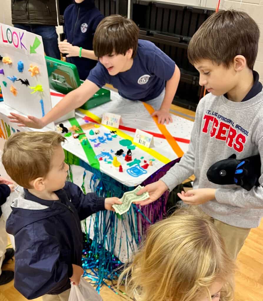 Students selling things at St. Lukes Trade Fair