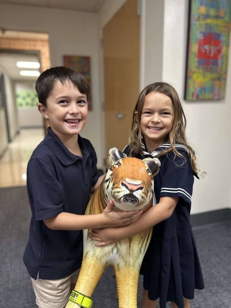 Siblings holding a Tiger