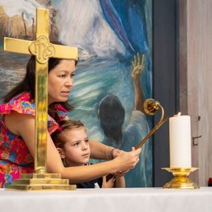 Chapel-Little Girl and woman lighting candle in Chapel
